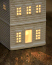 Load image into Gallery viewer, Decorative house-shaped night light with glowing windows on a wooden surface