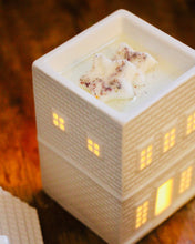 Load image into Gallery viewer, Ceramic building-shaped night light with a small candle inside on a wooden surface